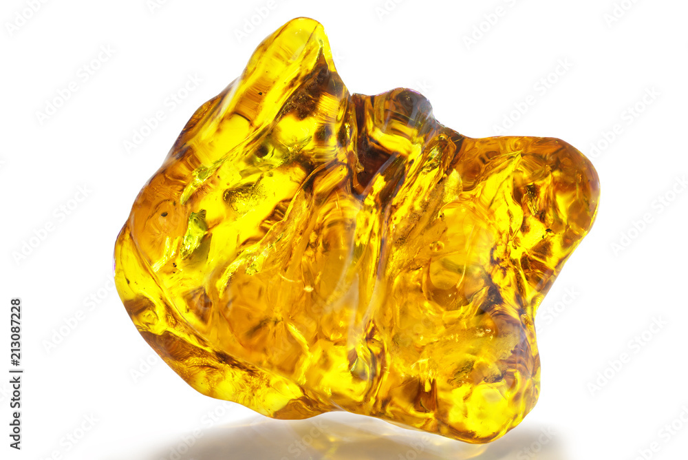 A beautiful polished transparent piece of amber with patterns and inclusions on a white background. A crystal made of natural natural wood resin. Amber material for jewelers. Sun stone, amber texture A beautiful polished transparent piece of amber with patterns and inclusions on a white background. A crystal made of natural natural wood resin. Amber material for jewelers. Sun stone, amber texture