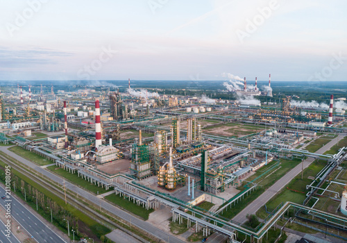 Oil refinery plant industry, Refinery factory, oil storage tank and pipeline steel with sunrise and cloudy sky background, Russia