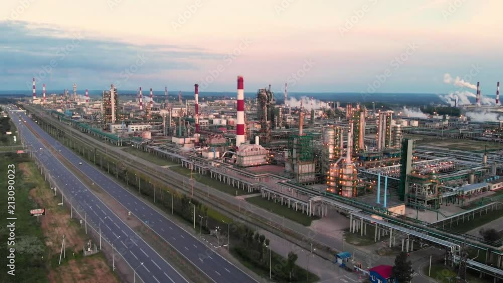 flight of the camera over the Oil refinery plant industry, Refinery factory, oil storage tank and pipeline steel with sunrise and cloudy sky background, Russia. flight of the camera over the Oil refinery plant industry, Refinery factory, oil storage tank and pipeline steel with sunrise and cloudy sky background, Russia.