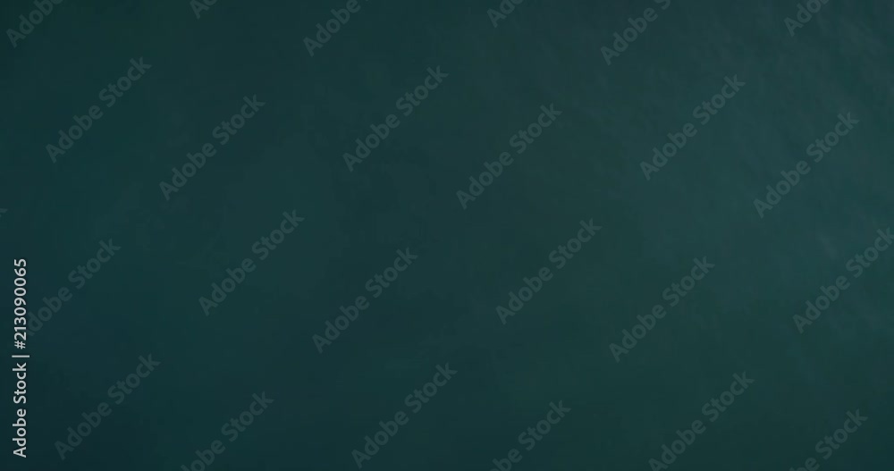 Aerial top down view of recreational speed boat in the atlantic sea, shot in Algarve destination, Portugal. Aerial top down view of recreational speed boat in the atlantic sea, shot in Algarve destination, Portugal.