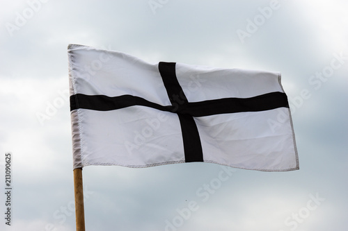 White medieval flag with a black cross