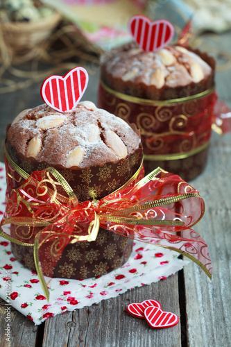 Saint Valentine's cake with red heart on the wooden table (panettone), selective focus