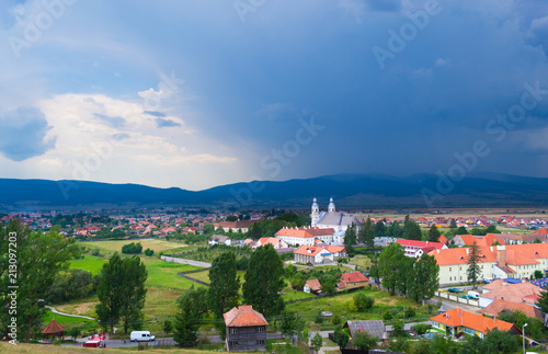 View of an approaching storm over Csiksomlyo, Transylvania. Blue clouds, hills in the background. photo