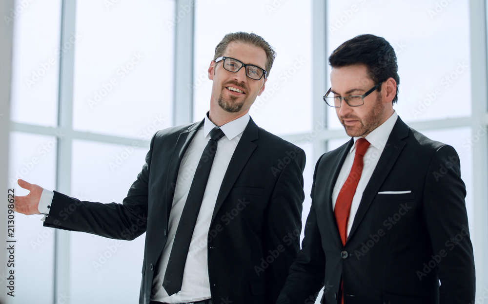 Two employees discuss the results of their work Two employees discuss the results of their work