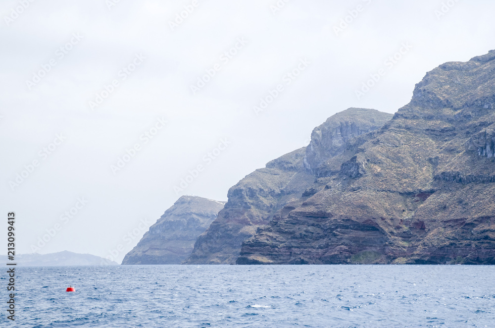 Steep shores of Island Terasiaamd island Santorini Steep shores of Island Terasiaamd island Santorini