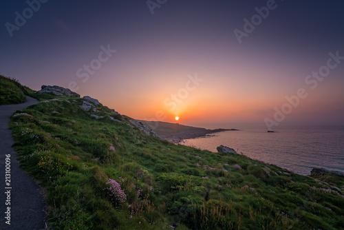 Walking path along the Cornish coast at sunset