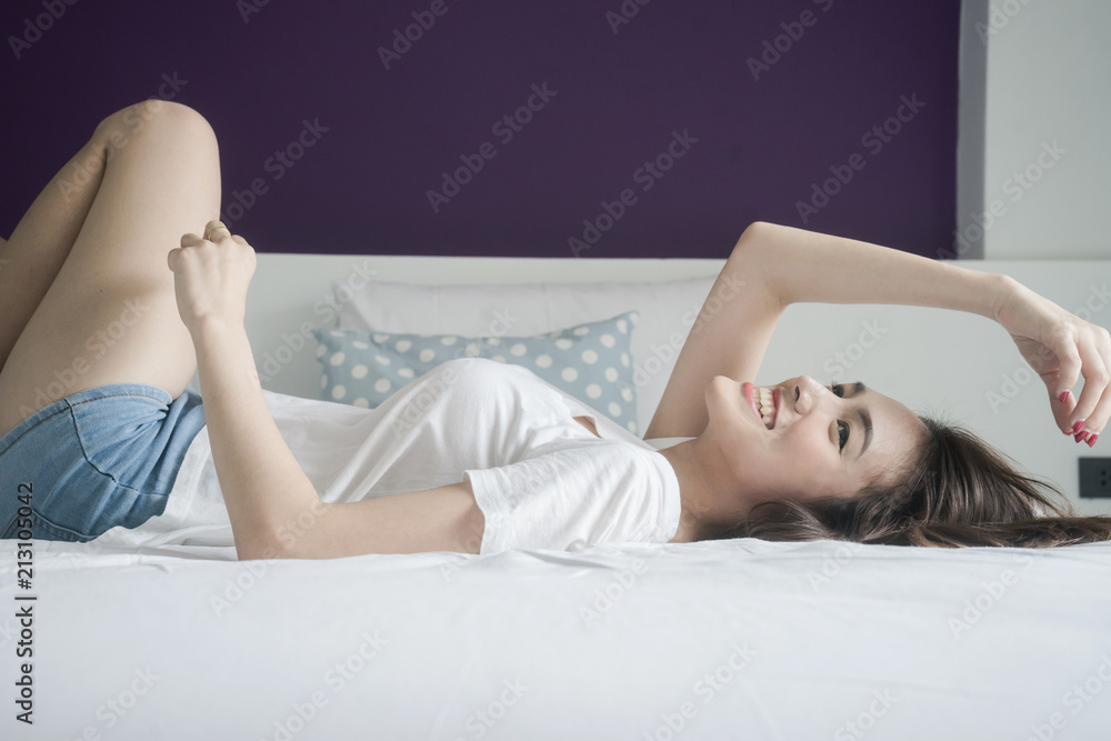 Obraz premium sexy woman is lying on her bed and look at camera in the morning