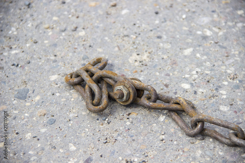 rusty chain. Asphalt pavement. bolted connection