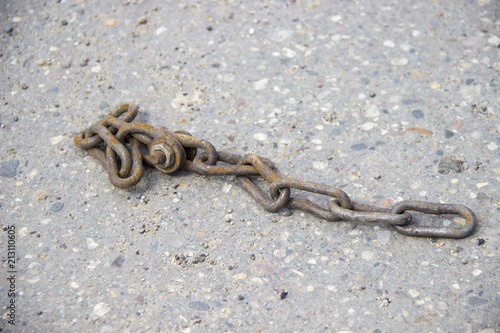 rusty chain. Asphalt pavement. bolted connection
