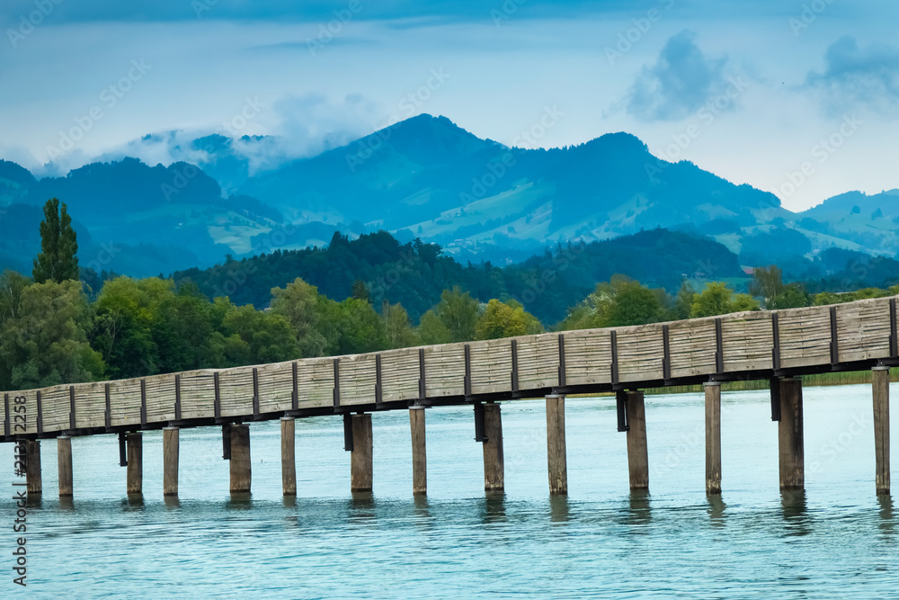 The Holzsteg, a wooden pedestrian bridge crossing the Zurich Lake (Obersee) at its narrowest point  Part of the eastern branch of the Way of Saint James