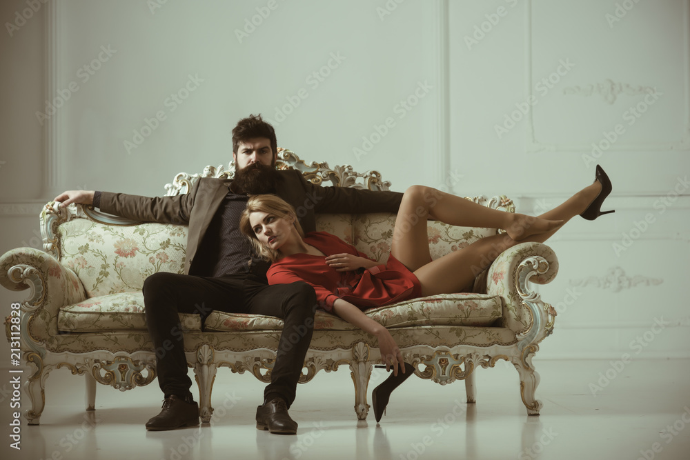 couple in love. family couple. sexy couple of bearded man and woman on sofa. couple relax at home. spending nice time at home. couple in love. family couple. sexy couple of bearded man and woman on sofa. couple relax at home. spending nice time at home.
