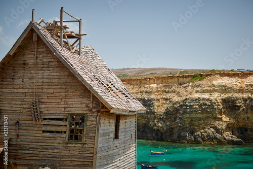 Fényképezés Rustic and ramshackle wooden house at Anchor Bay Malta