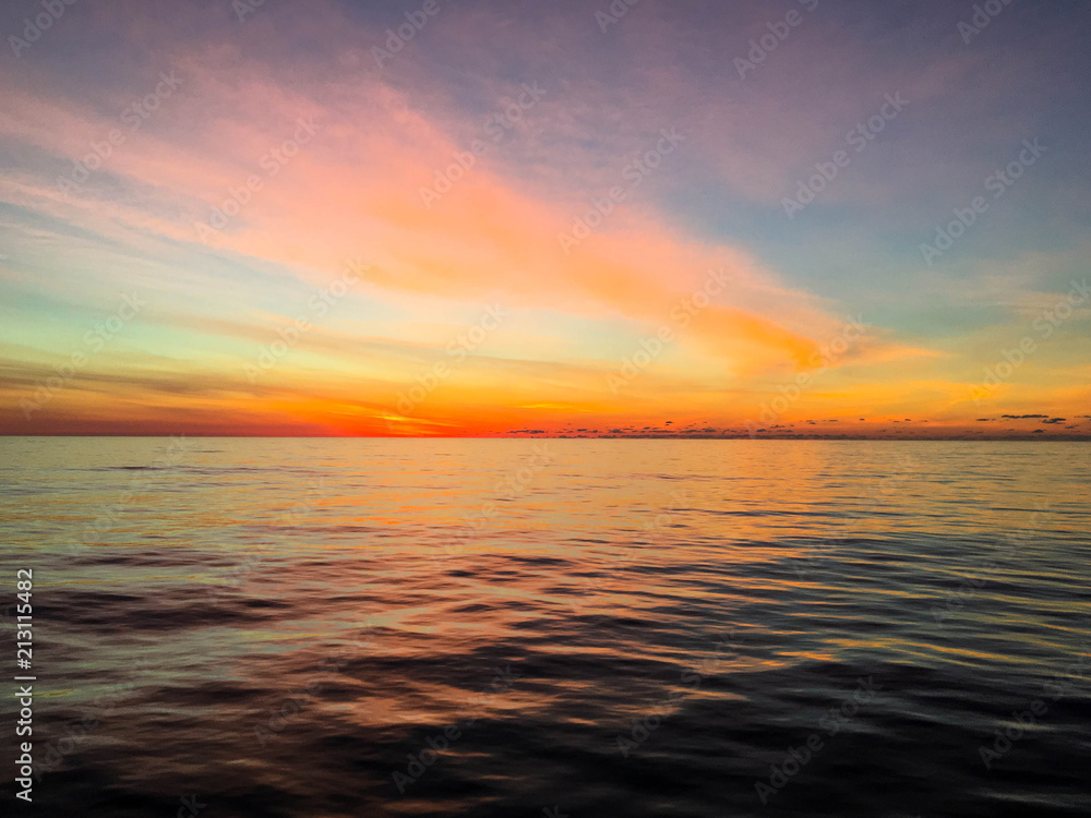 Colorful sky as dawn breaks over calm waters in the Atlantic Ocean
