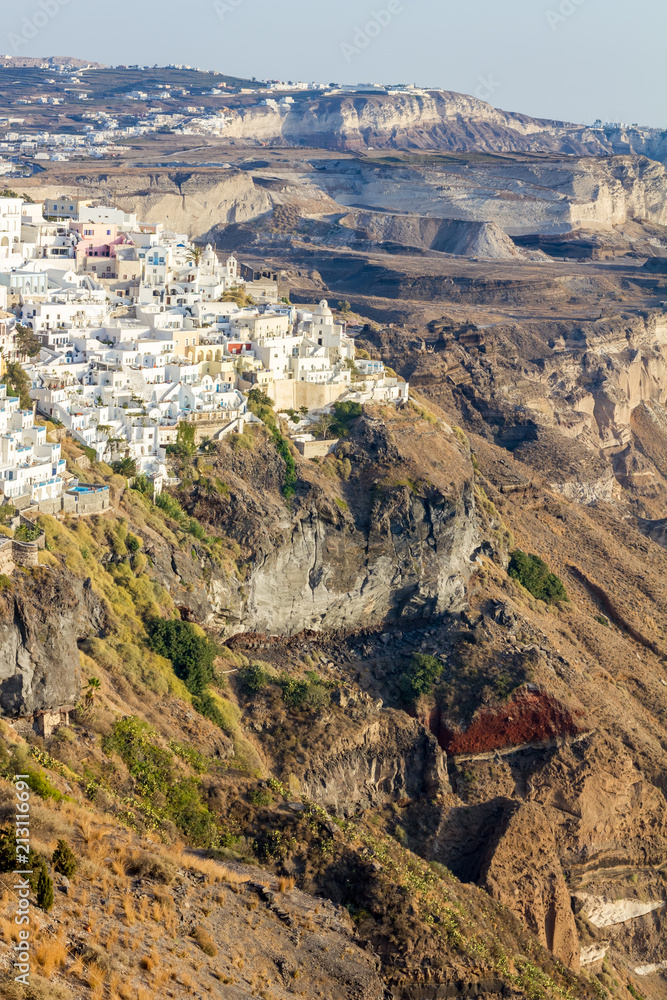 Elevated incredibly romantic scene on Santorini. Fira, Greece, from above. Amazing daytime partial view towards the colorful capital of the island. Shortly before the sunset
