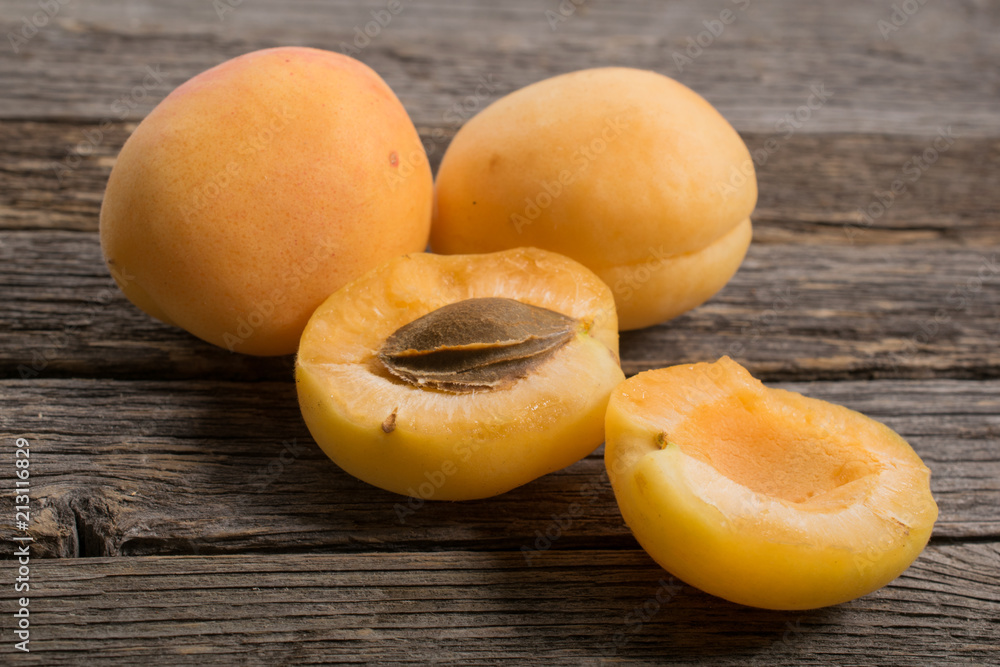 Group of apricots with kernel on wooden table. Closeup.