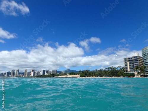 Historic Natatorium, Waikiki, Condomiums, Honolulu cityscape and San Souci Beach, coconut trees and lifeguard tower © Eric BVD