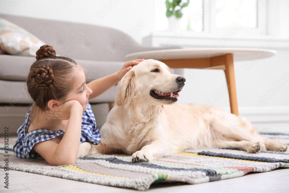 Cute little child with her pet on floor at home Cute little child with her pet on floor at home