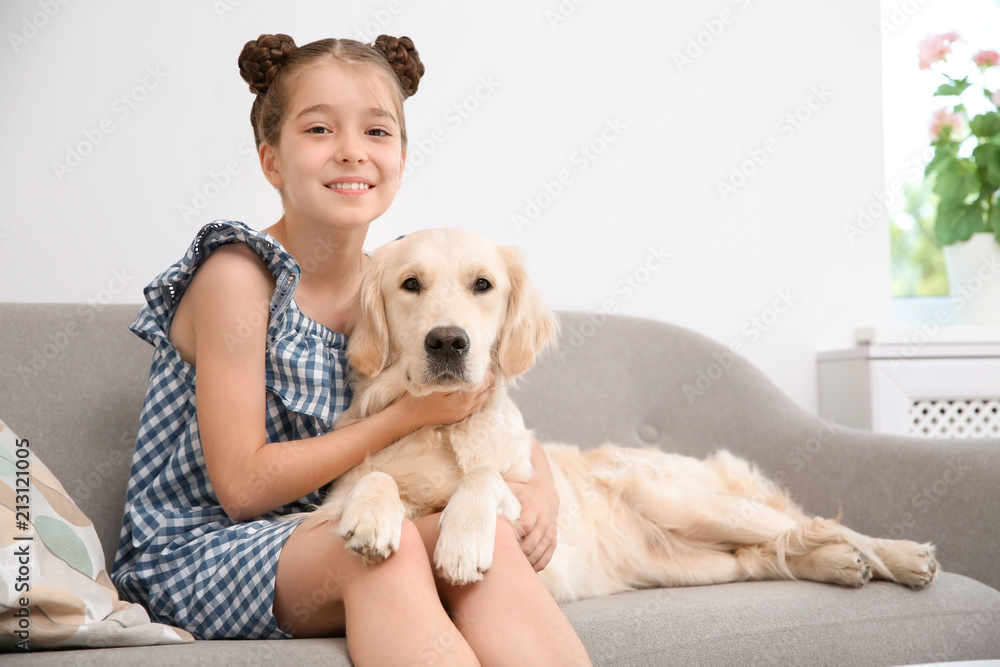 Cute little child with her pet on sofa at home Cute little child with her pet on sofa at home