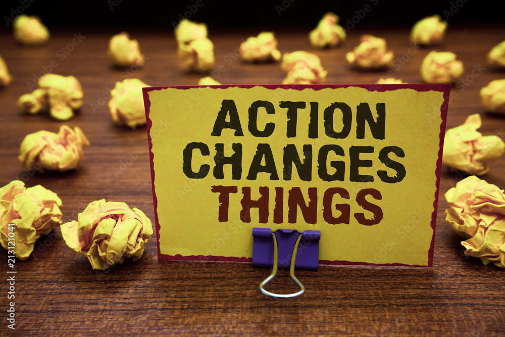 Naklejka premium Handwriting text writing Action Changes Things. Concept meaning doing something will reflect other things Reaction Yellow sticky card clipped text notice crumpled paper balls wood table.