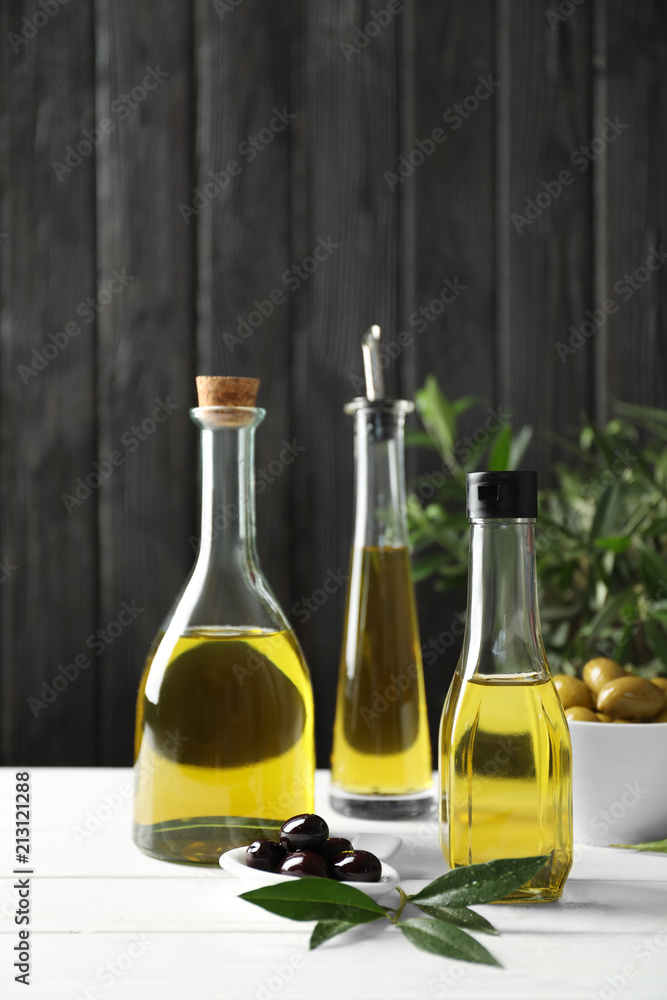 Composition with fresh olive oil on table Composition with fresh olive oil on table
