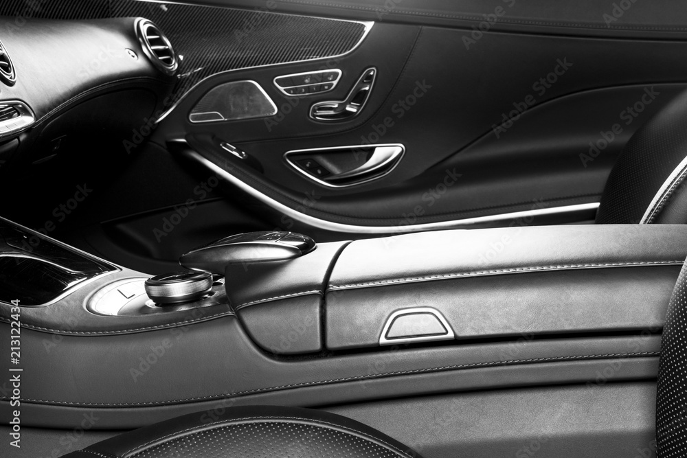 Modern Luxury car inside. Interior of prestige modern car. Comfortable leather seats. Perforated leather cockpit. Modern car interior details. Black and white
