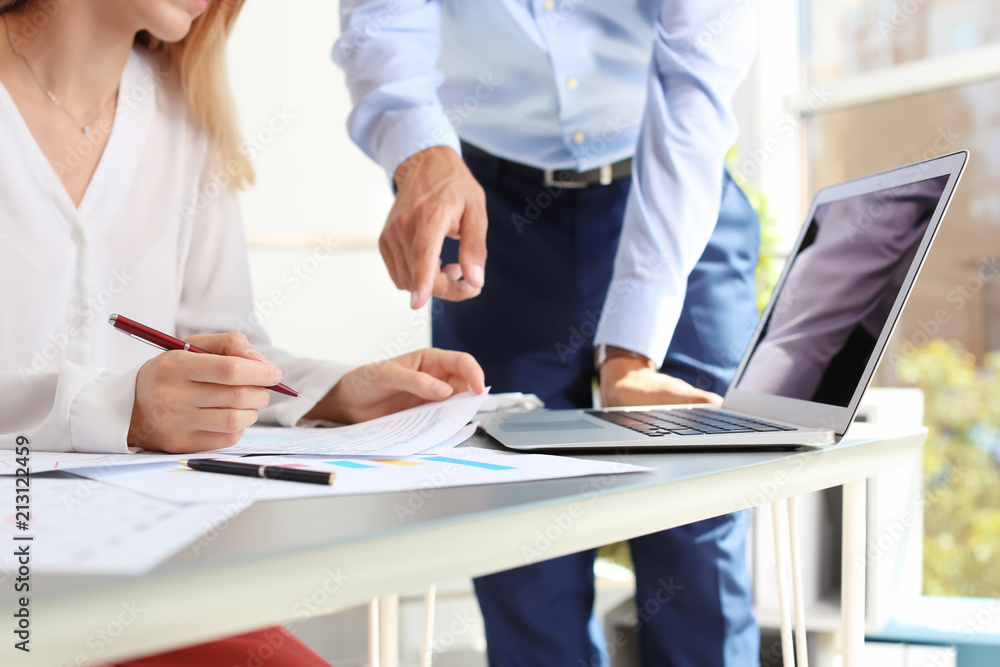 Tax accountants working with documents at table Tax accountants working with documents at table