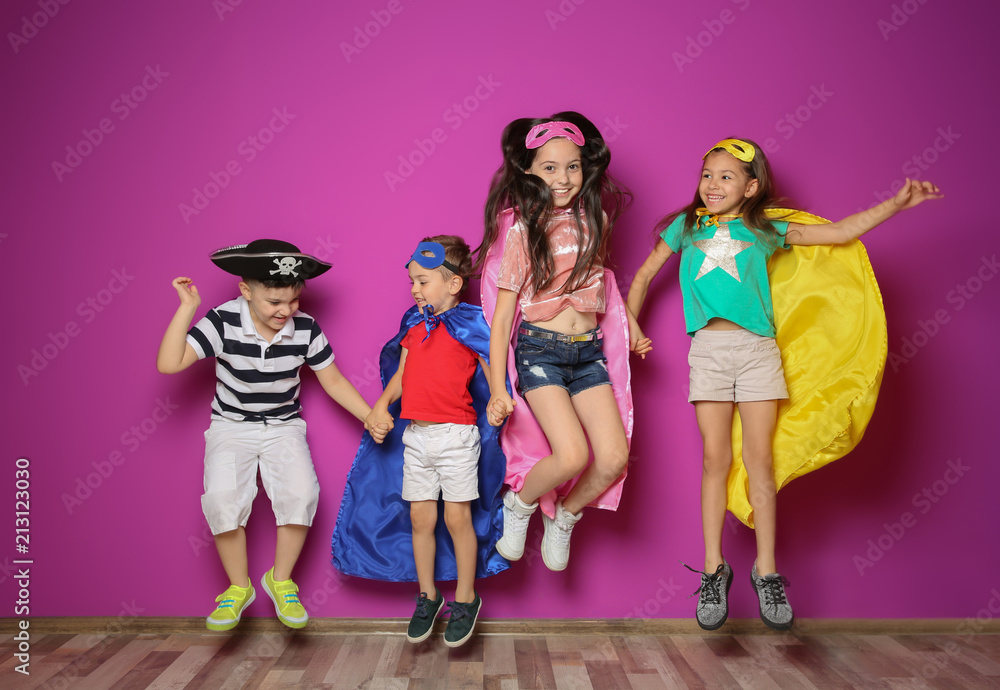 Fototapeta premium Playful little children in cute costumes indoors