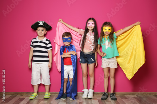 Playful little children in cute costumes indoors