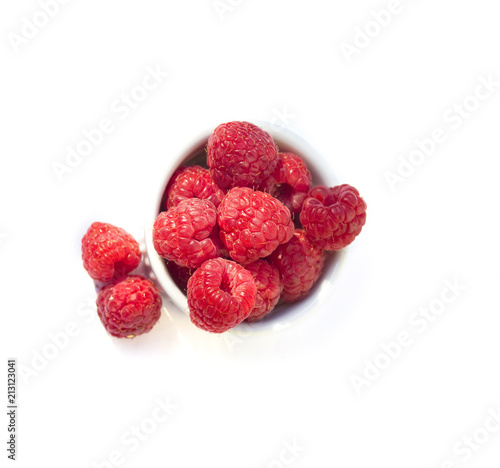 raspberry in white cup isolated on white