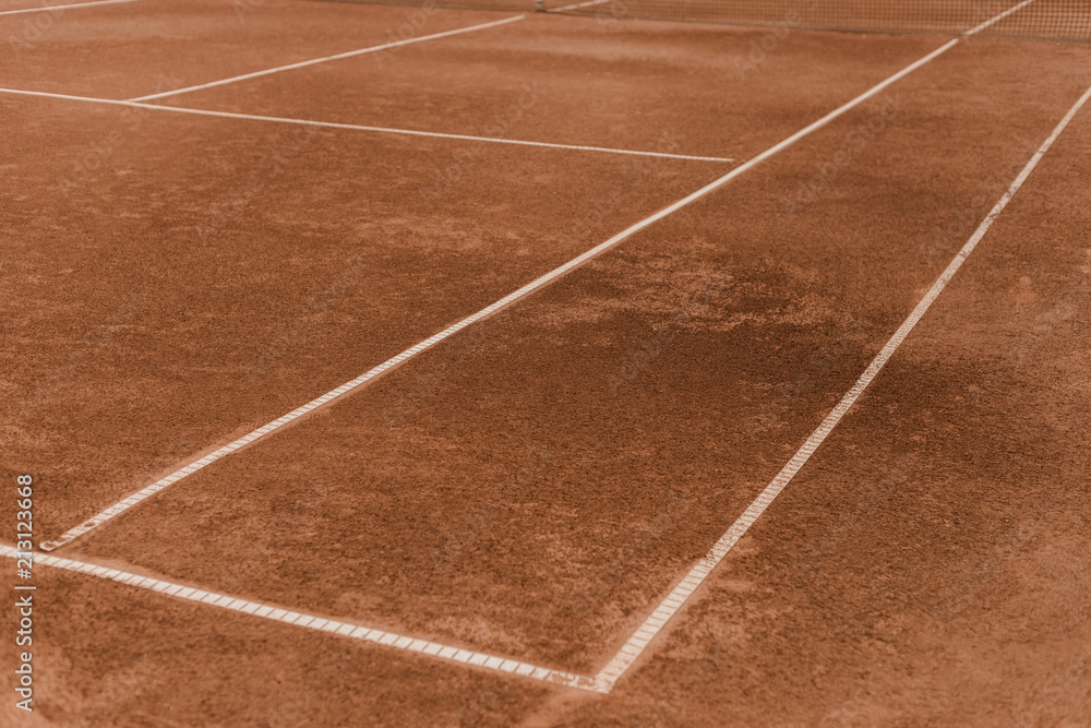 brown tennis court with white marking lines