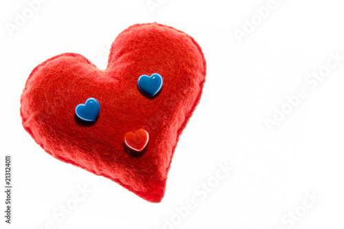 Close-up. Soft red heart. Emotion with blue eyes. A symbol of love and happiness. White background.