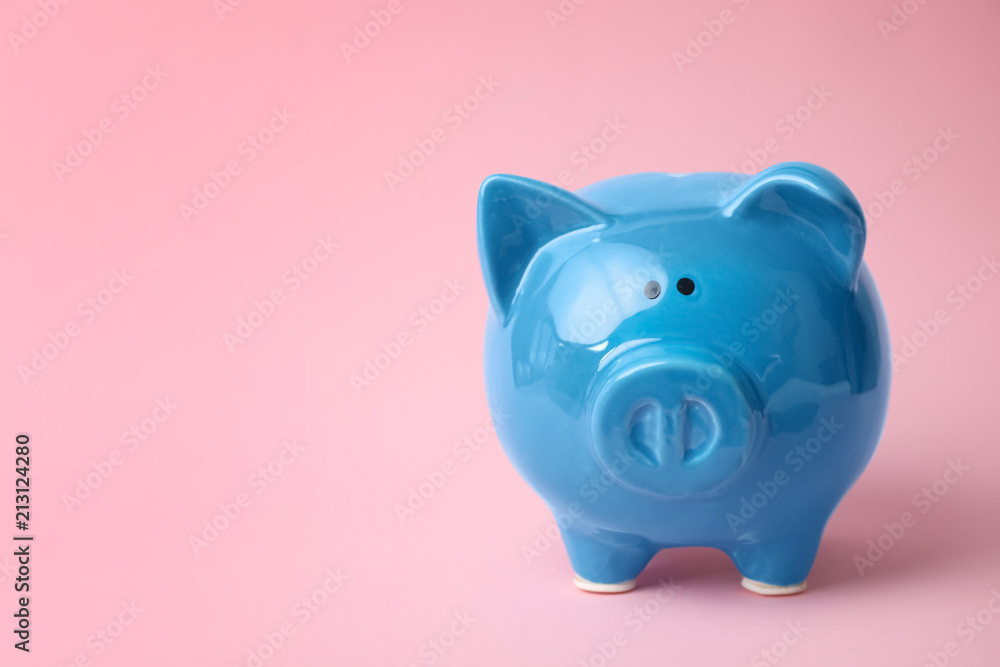 Blue piggy bank on color background. Money saving