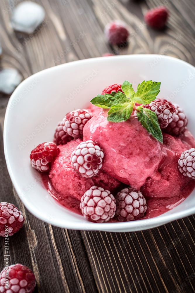 Delicious ice cream made from fresh berries on a wooden background Delicious ice cream made from fresh berries on a wooden background
