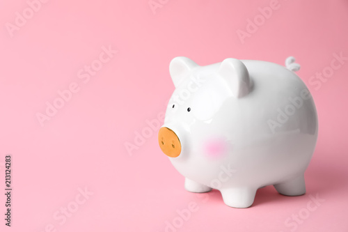 White piggy bank on color background. Money saving