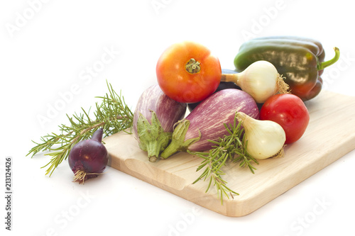Summer veggies with wodden cutting board on white
