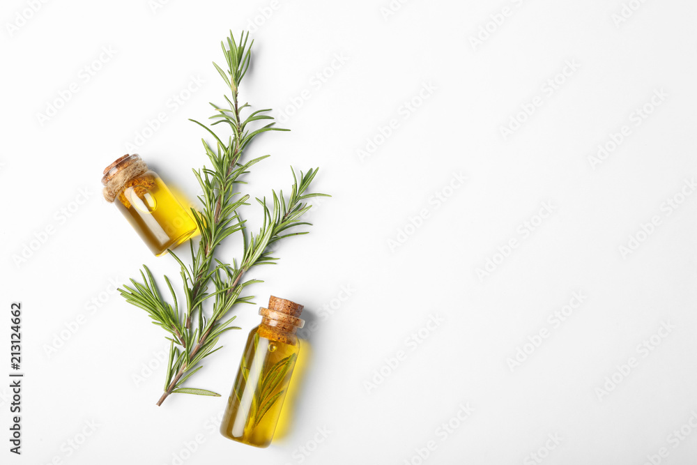 Composition with bottles of rosemary oil on white background, top view - obrazy, fototapety, plakaty 