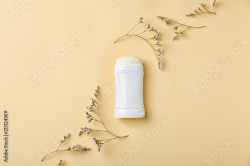 Fototapeta Naklejka Na Ścianę i Meble -  White deodorant and herbs on color background