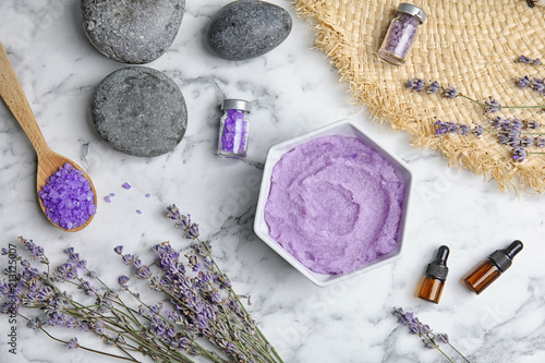 Flat lay composition with lavender flowers and natural cosmetic on marble background