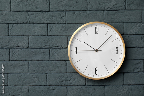 Modern clock on brick wall. Time concept