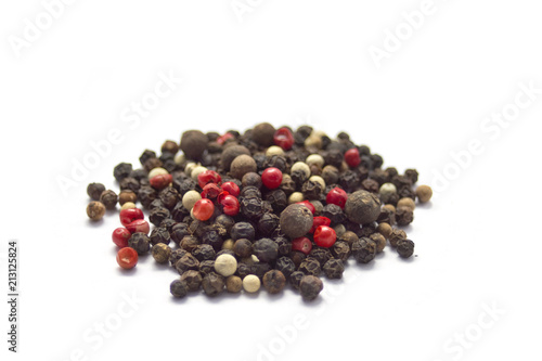 Stack of black, red and white pepper isolated on white