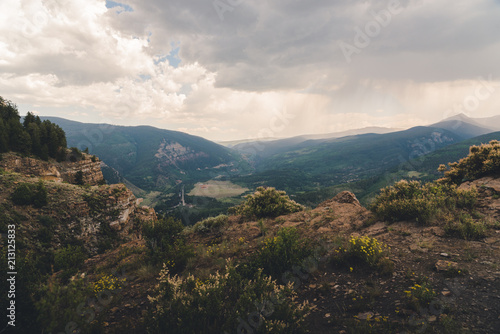 Landscape view of a mountain town in Colorado during a small thunderstorm