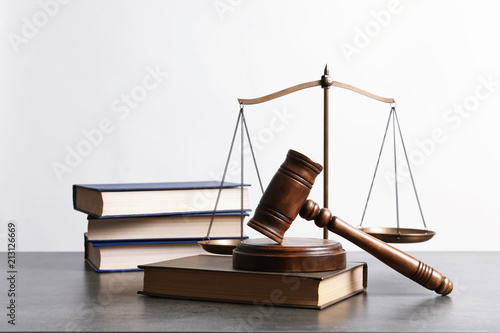 Wooden gavel, scales of justice and books on table. Law concept