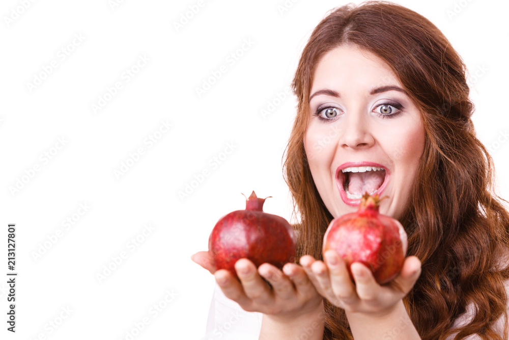 Cheerful woman holds pomegranate fruits, isolated Cheerful woman holds pomegranate fruits, isolated