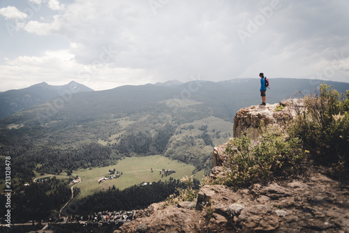 A man standing at the edge of a Cliff in Colorado.  photo