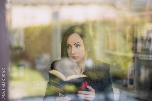 Beautiful young woman reading book