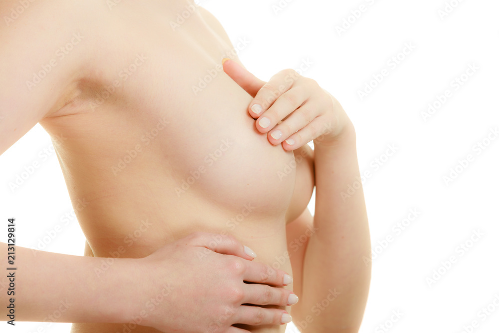 Woman examining her breasts for breast cancer Woman examining her breasts for breast cancer