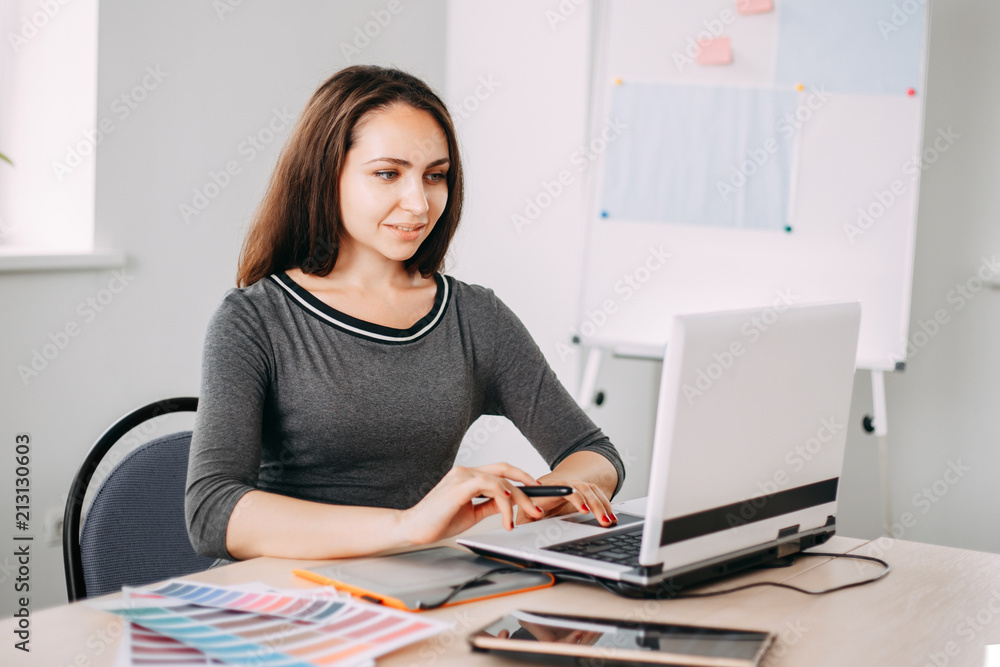 Graphic designer at work. Woman drawing using digital tablet and laptop. Design, innovations, creative work and new projects Graphic designer at work. Woman drawing using digital tablet and laptop. Design, innovations, creative work and new projects