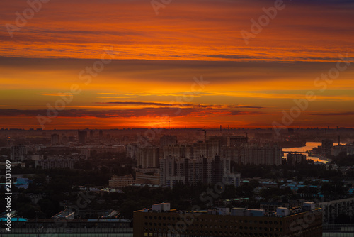 City during warm sunset. Cityscape panorama at summer sunset. Orange sky on sunset in big city. Saint-Petersburg skyline in sunset, Russia.