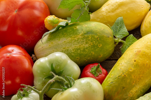Garden fresh squash cucumber tomato onion pepper with background copy space photo