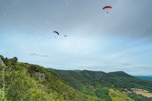 Group of paragliders above mountains